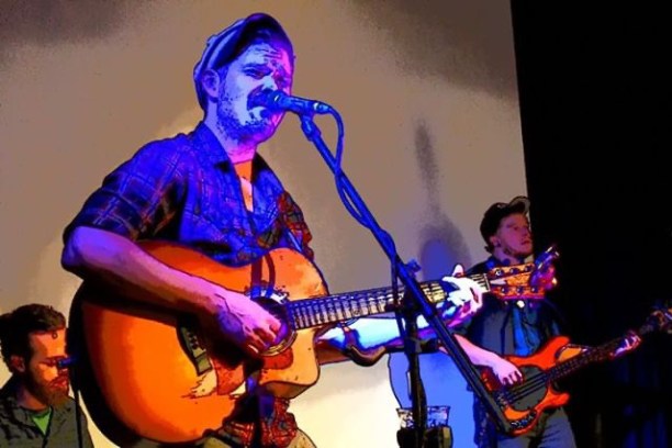 a man on a stage playing instruments