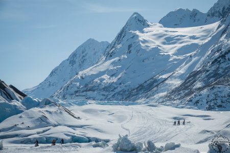 a man standing on top of a snow covered mountain