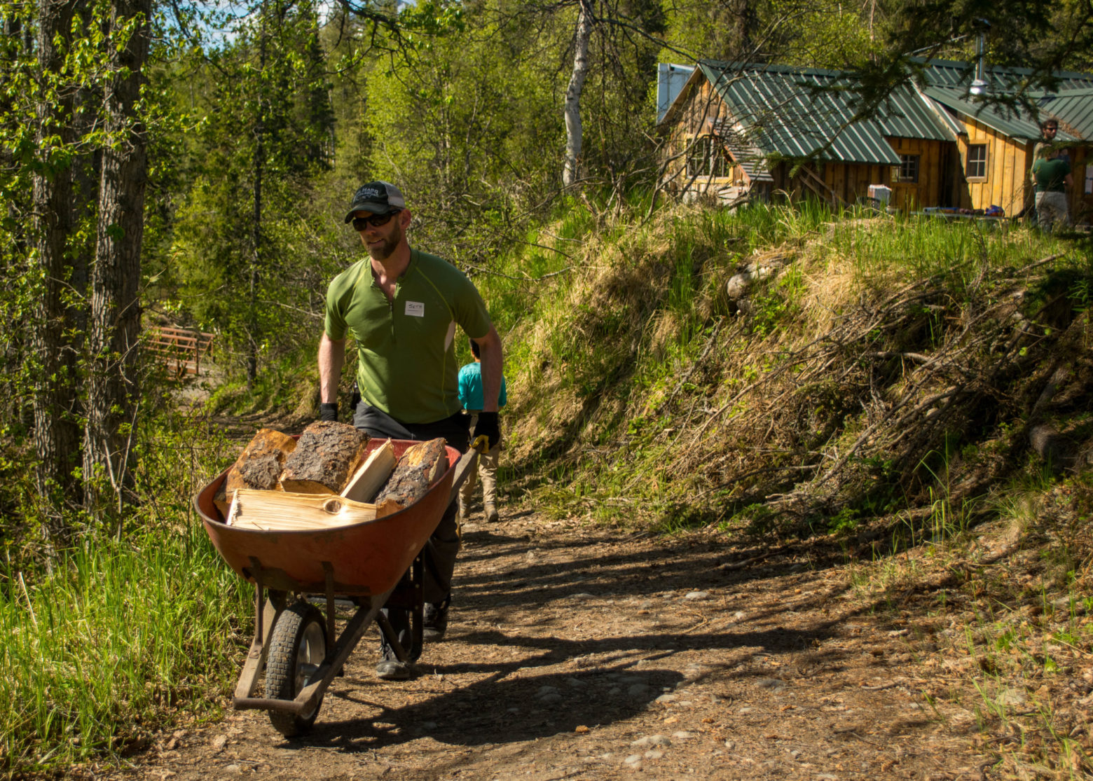 a man riding a bike down a dirt road