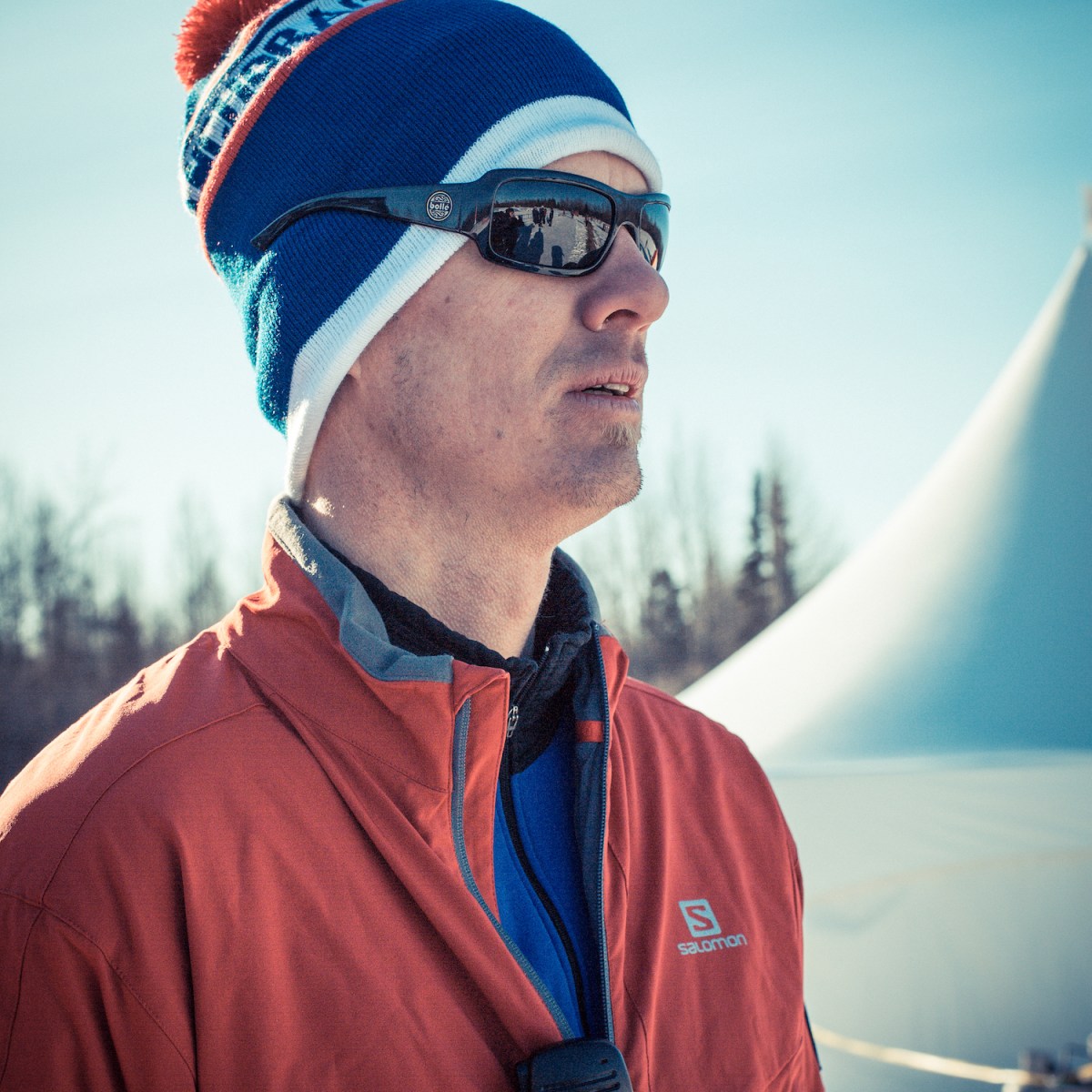 a man wearing a hat and sunglasses