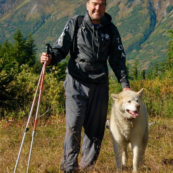 a man standing in front of a mountain