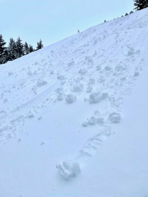 a man riding skis down a snow covered slope