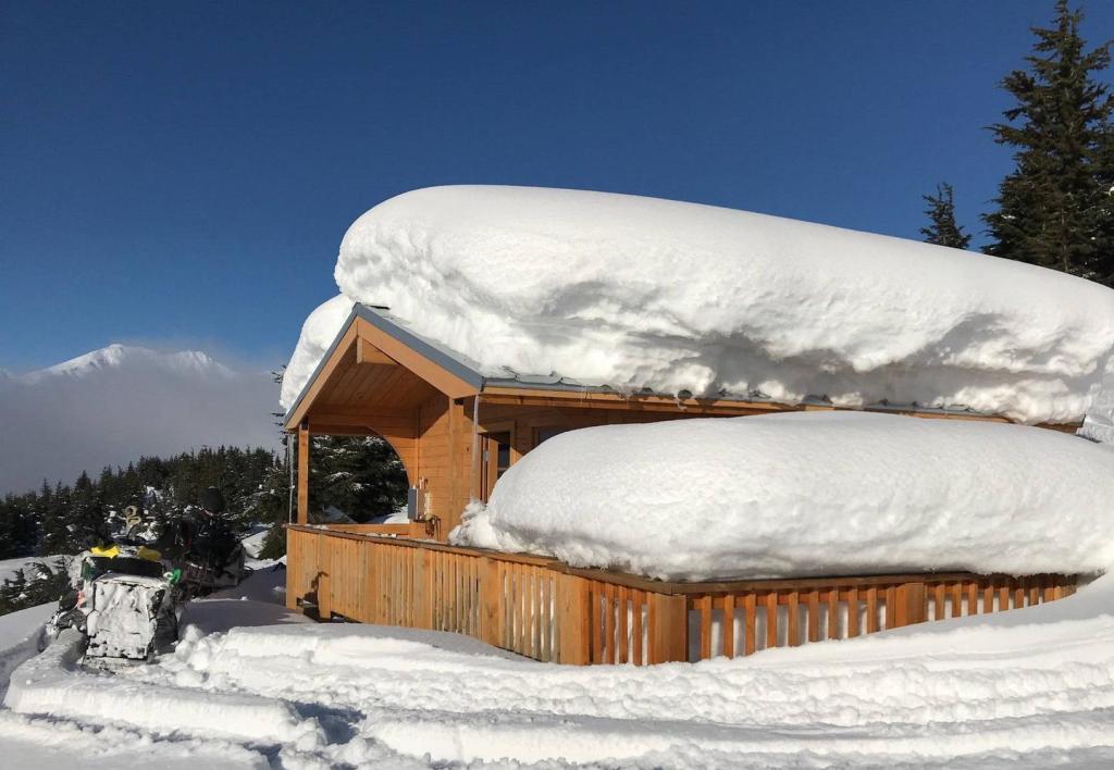 a person riding a snowboard down a snow covered slope