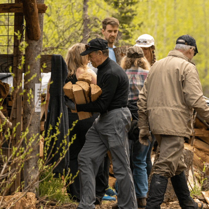 a group of people standing next to a tree