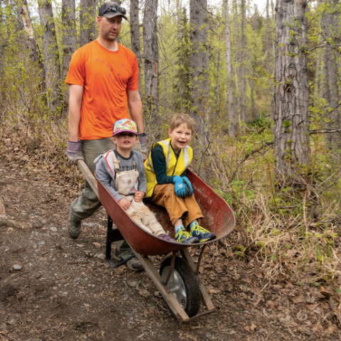 a man sitting in a wooded area