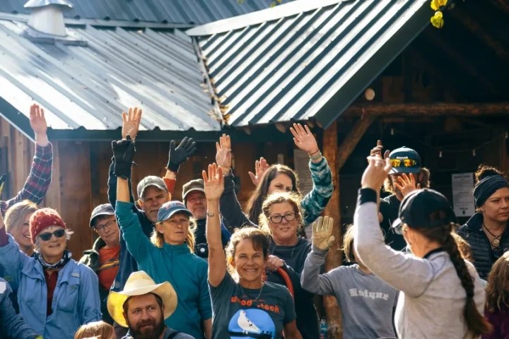 a group of people standing in front of a crowd posing for the camera